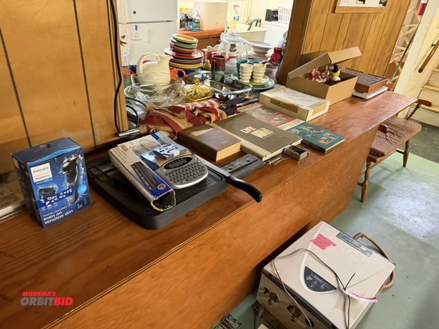 Lot 1-12196 - Contents on cabinet, includes Norelco shaver, Brother P-touch Label System, Paper cutter, assorted P...