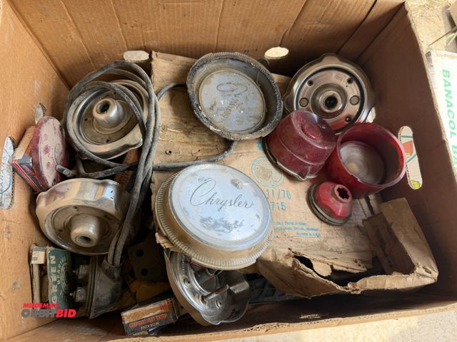 Lot 1-8569 - Large lot of assorted vintage car parts, includes lenses, Chrysler caps, bearings, and more.