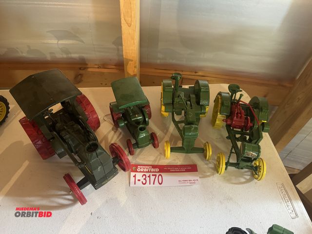 Lot 1-3170 - (4) Die cast tractors including; (2) water Loo boy oil pull, (1) Rumley oil pull, and (1) oil pull t...