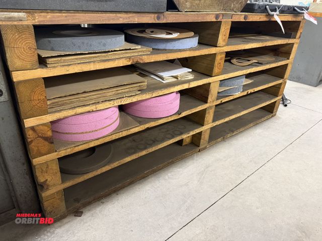 Lot 1-1808 - (1) wooden bench, 74" long, filled with assorted grinding wheels and parts.