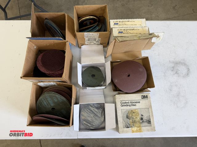 Lot 1-6175 - Lot of assorted abrasives, including (2) boxes of Norton 7" x 7/8", 120-grit sanding discs, (2) boxe...