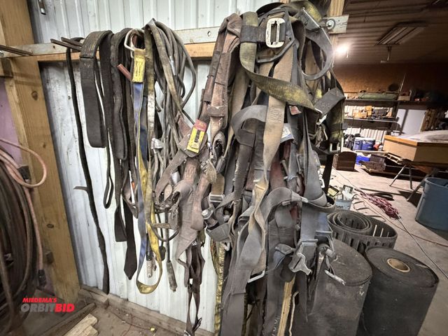 Lot 1-1495 - Large lot of assorted fall safety harnesses, lift slings, fall safety harness lanyards, and miscella...