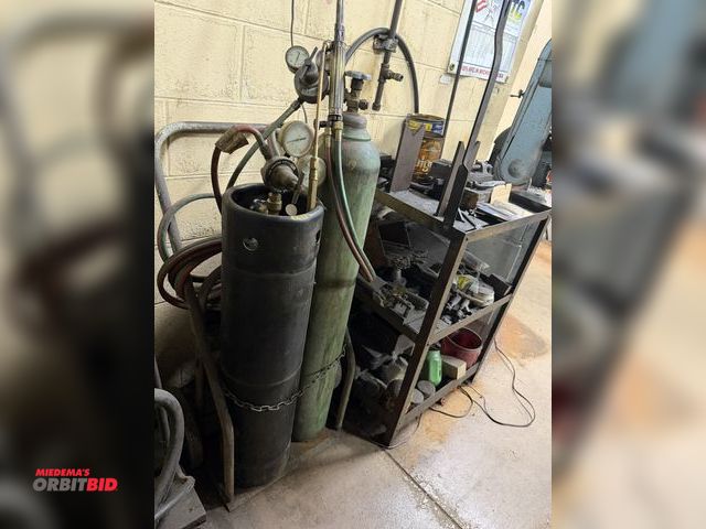 Lot 1-11039 - (1) oxygen/acetylene torch cart with gauges, torches, etc., includes table and contents, 3" speed vi...