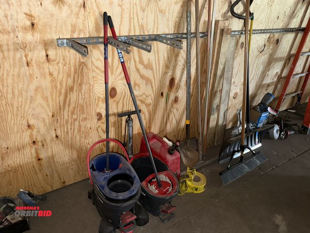 Lot 1-13175 - Large lot of assorted hand tools, includes brooms, mop buckets, gas can, Caution tape, and more.