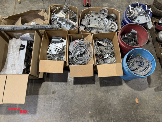 Lot 1-1519 - Large lot of assorted garage door components, includes various pulleys, cables, brackets, (1) Chambe...