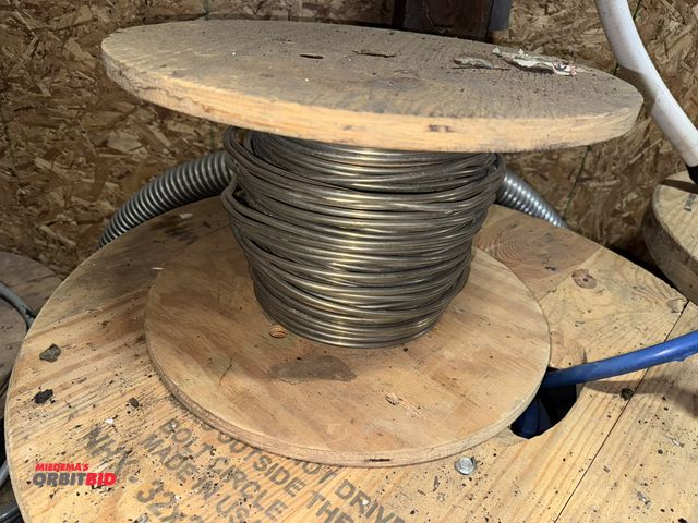 Lot 1-4295 - (1) partial spool of solid aluminum wire, unknown thickness/gauge, approx. 1/4" diameter.