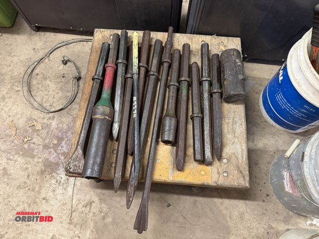 Lot 1-6358 - Lot of assorted jack hammer attachments, includes points, chisels, (1) 10 lb. sledgehammer head, and...