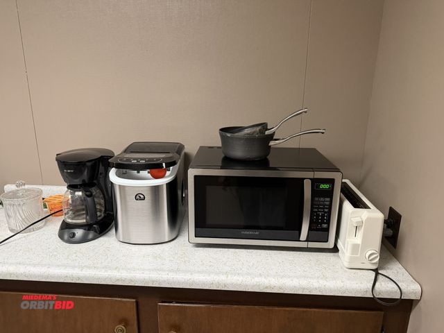 Lot 1-15502 - (1) Mr. Coffee 12-cup coffee maker, (1) Igloo table top ice maker, (1) Farberware microwave oven, (1...