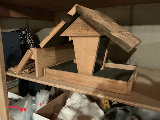 Lot 1-19307 - (1) wooden birdhouse 19” x 15” tall includes one wooden shelf 21 inches wide.