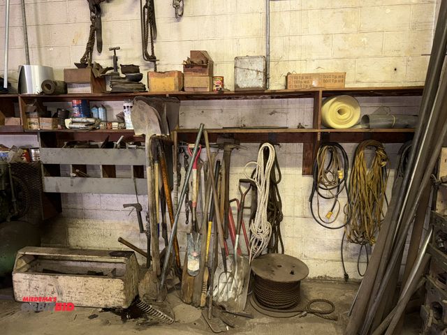Lot 1-18218 - Entire content of items shown on wall and in wood shelf, includes assorted hammers, rakes, pickaxes,...