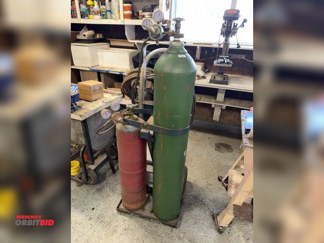 Lot 1-12130 - (1) torch set up, includes oxygen bottle, approx. 50" tall, acetylene bottle, approx. 32" tall, regu...