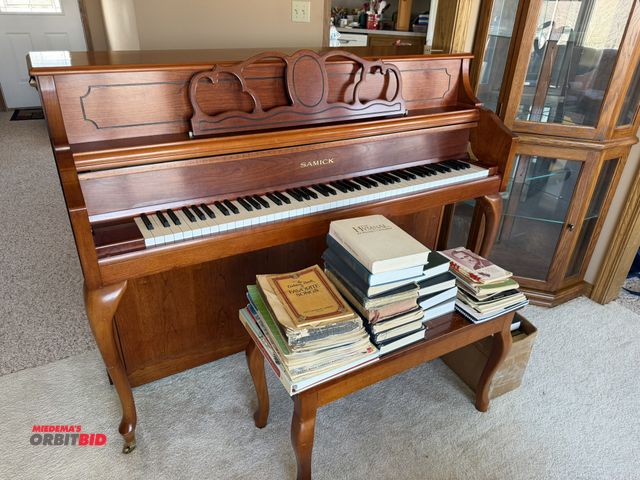 Lot 1-19189 - (1) Samick piano, made in Korea, includes bench and sheet music.