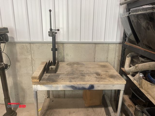 Lot 1-18766 - (1) spring style press, approx. 20" tall, mounted to a stainless steel table base with wood top, 48"...