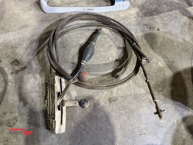 Lot 1-1543 - (1) vintage Johnson Ship-Master shift cable with control, and (1) outboard engine fuel priming bulb.