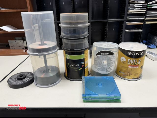Lot 1-1098 - Lot of assorted new, DVDR discs. (1) Neato CD label applicator, (6) 12" x 6" x 5" plastic disc racks...