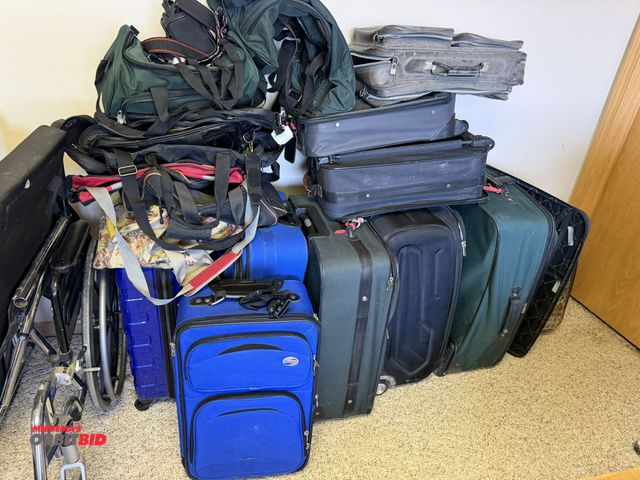 Lot 1-19204 - Large assortment of suit cases and duffle bags.