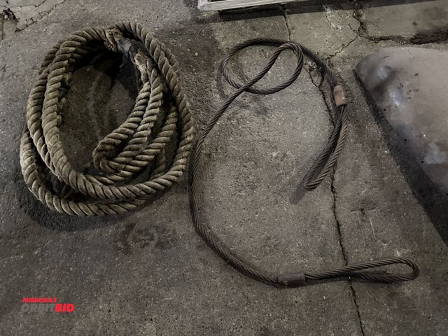 Lot 1-1284 - (1) approx. 10' long steel wire choker, and (1) approx. 20' long x 1.5" diameter tow rope.