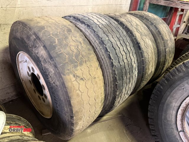 Lot 1-18182 - Lot of (4) various size 385/65R 22.5 tubeless tires with 10-lug rims.