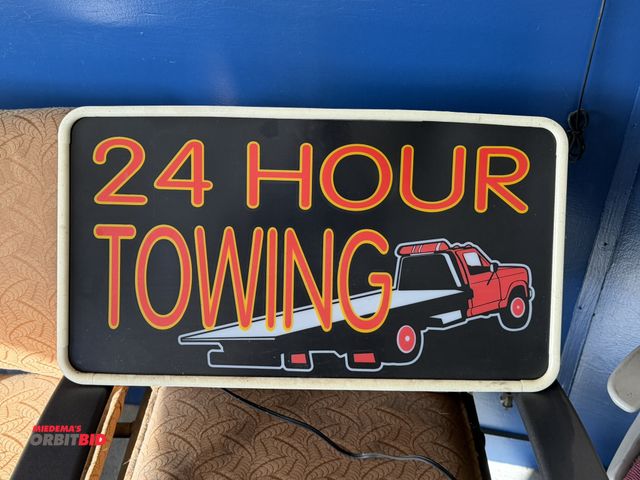 Lot 1-1292 - (1) 24" wide x 13.5" tall hanging, lighted 24 Hour Towing sign.