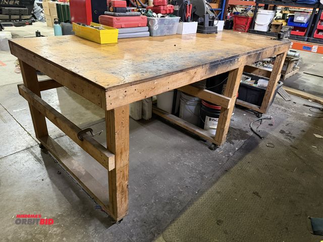 Lot 1-18528 - (1) 96" length x 37.5" height x 48" depth wood work bench on wheels with a 4" bench vise mounted to ...