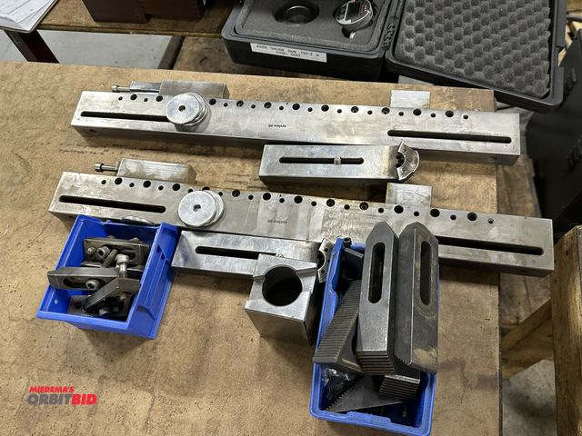 Lot 1-19502 - Lot of assorted hold down equipment with (2) 24" long custom made machined vise units.