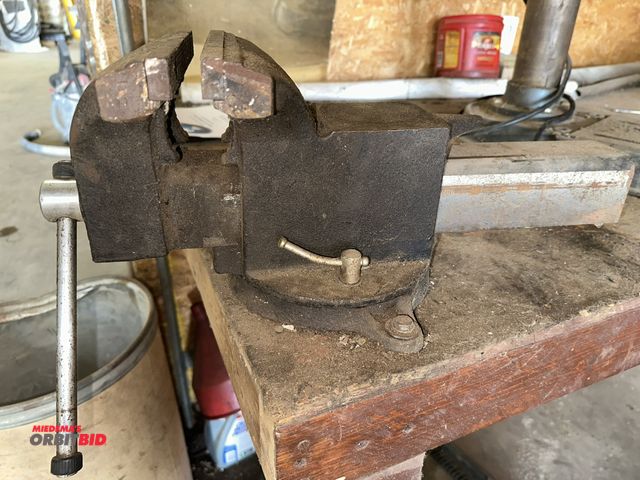 Lot 1-14185 - (1) 8" bench vise with anvil top (bolted to a wood bench, will require tools for removal), winning b...