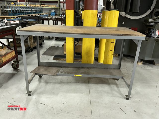Lot 1-19188 - (1) 60" length x 38.5" height x 30" depth steel framed table with plywood/wood composite top.