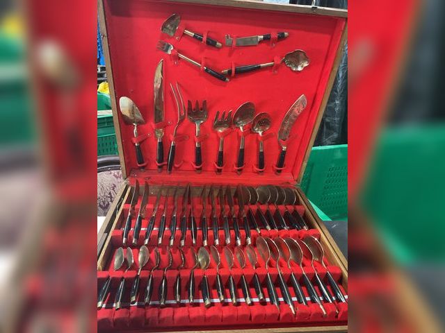 Lot 106-001229 - Full set of gold color silverware. Black handles. No pieces missing. Comes in solid wood carrying ca...