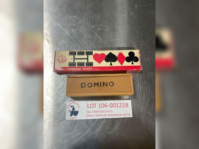 Lot 106-001218 - One box of wood dominos. One cribbage board. No pieces appear to be missing.