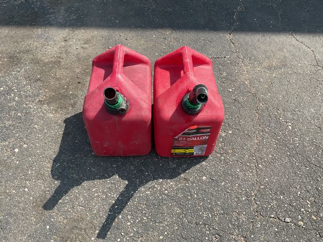 Lot 106-00251 - Two, two gallon gas cans. No cracks or leaks. One has a nozzle with a tip. One has a nozzle with no tip.