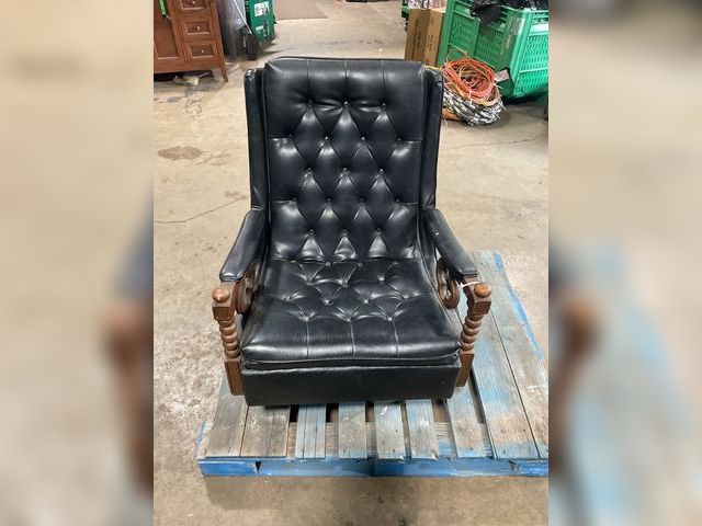 Lot 106-001185 - Black leather swivel and rocking chair. Some dirt around buttons. 28 inches wide by 36 inches tall