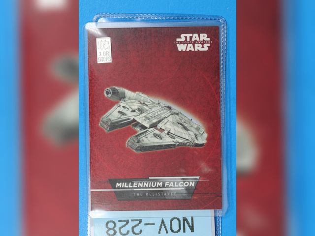 Lot 108-228 - 1 GRAIN 999 SILVER BAR ATTACHED TO A TOPPS STAR WARS MILLENNIUM FALCON CARD