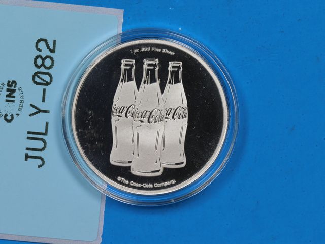 Lot 108-082 - 1oz 999 SILVER COCA COLA COKE LOGO SILVER BULLION ROUND