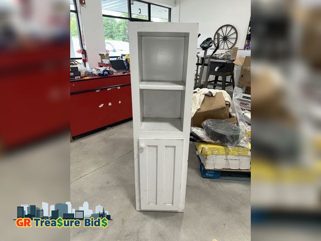 Lot 111-36517 - tall, slender white cabinet or shelving unit. It has two open shelves in the upper section and a clo...