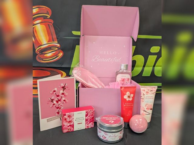Lot 112-0219-22A - New LUCOTIYA  cherry blossom gift box. Includes scented soy wax candle, sleep mask, loofah, bath bom...