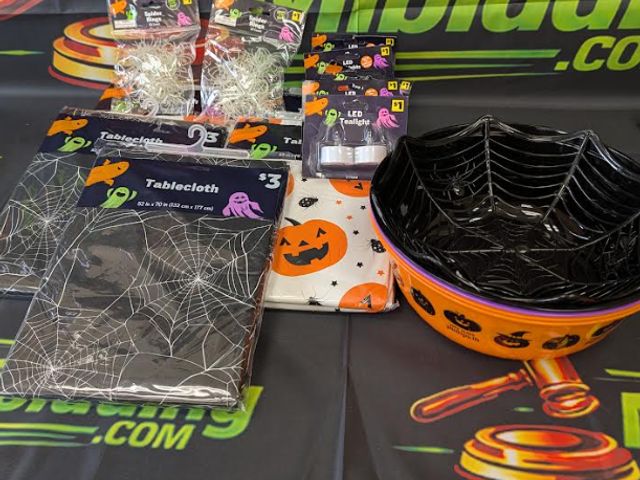 Lot 112-0527-23B-1 - Assorted Halloween lot. Includes (5) Halloween themed tablecloths, (5) 2-pack LED tea lights, (2) pa...