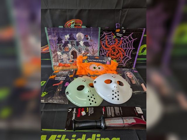 Lot 112-0523-23B-1 - Assorted Halloween lot. Includes (3) masks, (1) bloody blade, (3) trick or treat bags, (3) kids mask...