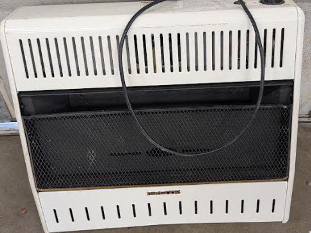Lot 112-0512-garage - Gas wall heater ProCom wall hanging ventless heater. Used.