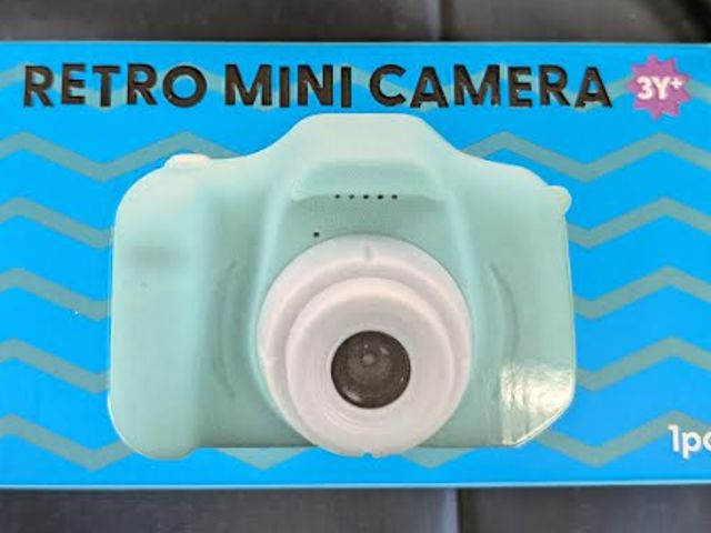 Lot 112-0256-22B - Retro mini camera with USB cable for charging. Light blue. New.