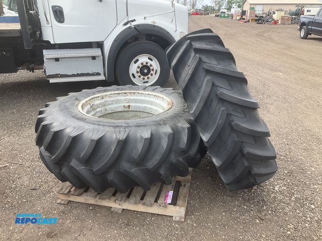 Lot 2-22989 - (1) 16.9R28 tractor tire (some cracking in the sidewalls) and (1) 18.4-30 tractor tire on a dual ste...