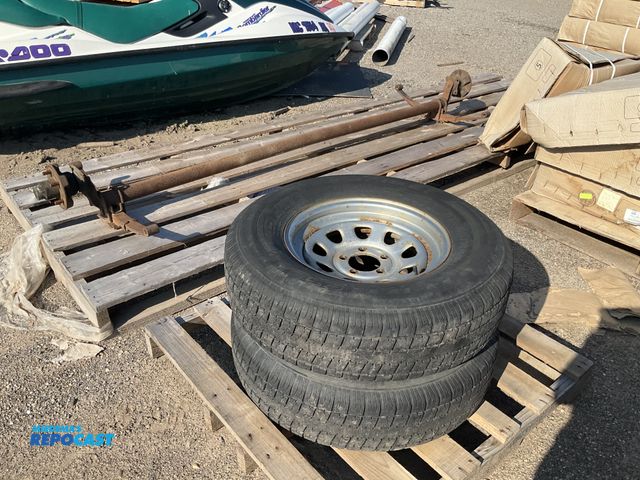 Lot 2-99088 - (3) 2 tires with rims castle rock ST226 radial ST225/75R15 and an axle 100” long