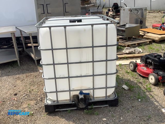 Lot 2-64499 - 11,800 BTU IBC Tote 275 GAL bulk container tank used for liquid storage and transport.
