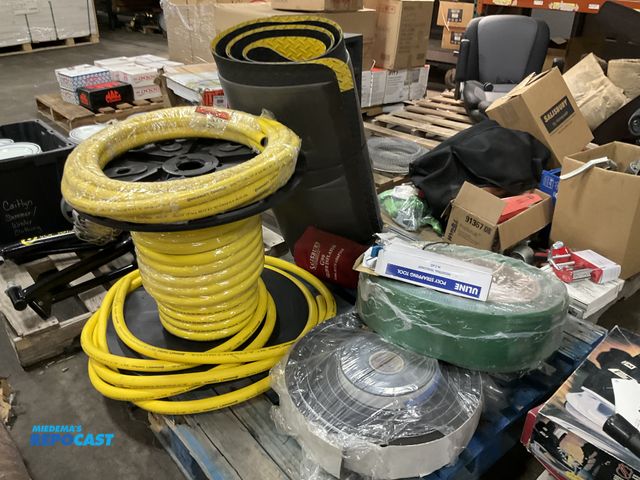Lot 2-10319 - Skid lot spool of rubber hosing a roll of foam roll of plastic Polly strapping tools a safety black ...