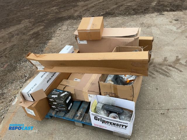 Lot 2-11515 - Skid of assorted semi truck parts, some new and some used, includes Freightliner Headlight, (2) Auto...