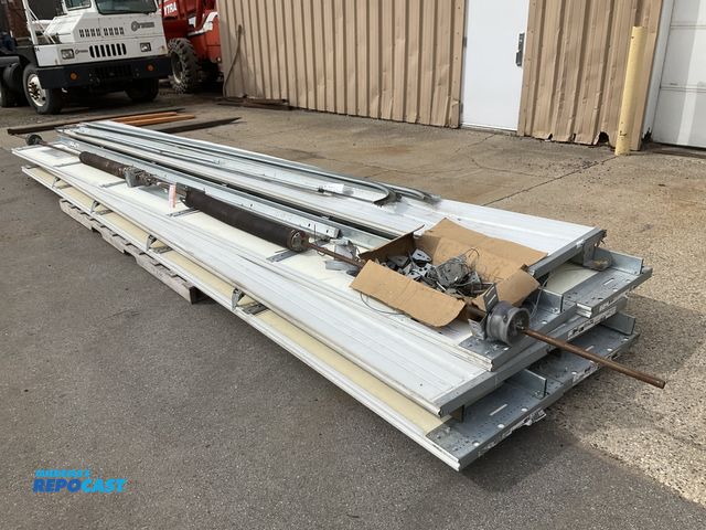 Lot 2-42332 - Clopay 20’W x 14’T insulated garage door with track, rollers, spring and cables, one panel has three...