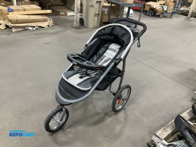 Lot 2-67399 - Graco Three wheeled Jogging stroller with canopy, cup holders, and storage area underneath , black