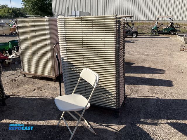 Lot 2-13926 - Chairs Stack of plastic and metal foldable chairs white on a metal rolling cart