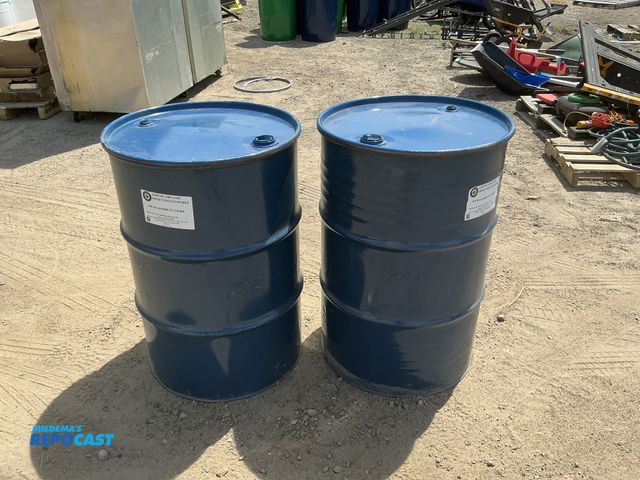 Lot 2-75876 - 2 55 gallon blue steel barrels with removable lids and locking rings, clean inside, contained a food...
