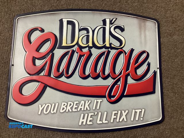 Lot 2-34603 - New Metal sign by Open Road. Dad’s Garage. YOU BREAK IT HE’LL FIX IT! Measures approximately 11” X 1...