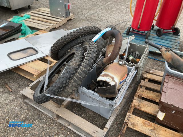 Lot 2-92523 - Suzuki Pallet lot of motorcycle parts including: tires, Suzuki piece, light, and more miscellaneous ...